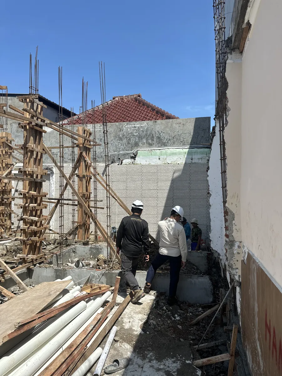 Tim Madina Build berhelm proyek memeriksa besi kolom dan bekisting sebelum pengecoran